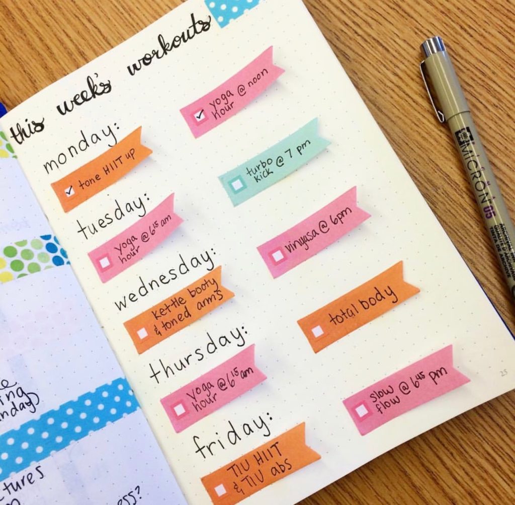 A reusable workout schedule in my bullet journal using sticky notes. I share over ten different ways that you can use a bullet journal to track health and fitness in this post! #bujo #bulletjournal #stickynotes
