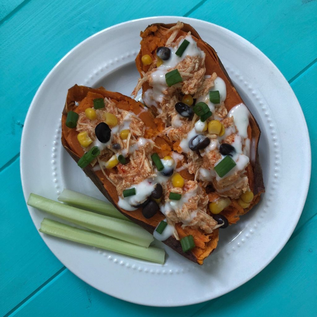 Healthy buffalo chicken stuffed sweet potato recipe. Learn how to make the best healthy buffalo chicken in the crockpot! Then, make meal prep easier and more exciting with these four recipes all using the buffalo chicken! #healthycrockpotrecipe #healthyslowcookerrecipe #healthybuffalochicken #mealprep