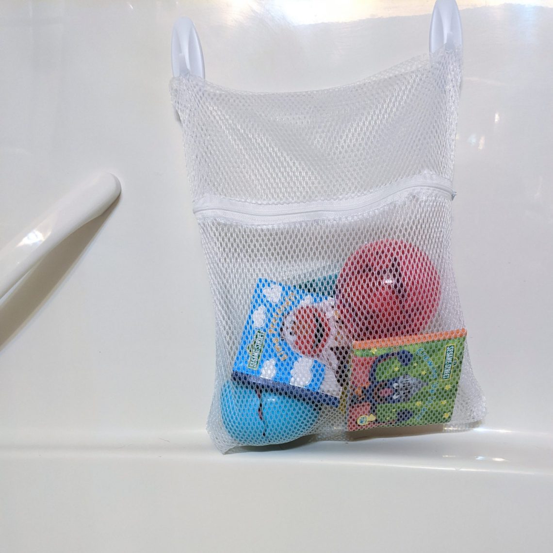 How to simplify and organize the kids' bathroom. Organize the bath toys using laundry bags from the Dollar Tree! #kidsbathroomhacks #kidsbathroom #kidsbathroomideas #organization