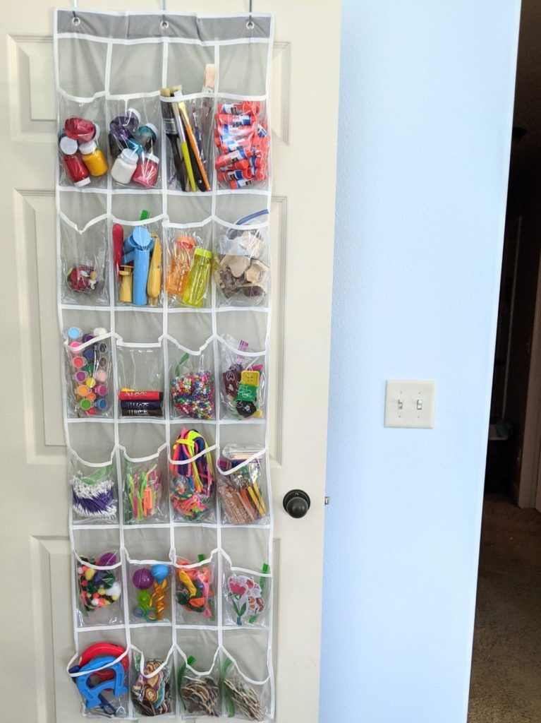 A simple kids craft supply organization idea: use an inexpensive over the door shoe organizer to keep small pieces tidy. #cheap #inexpensive #frugal #artsupplies #artsandcrafts #organization